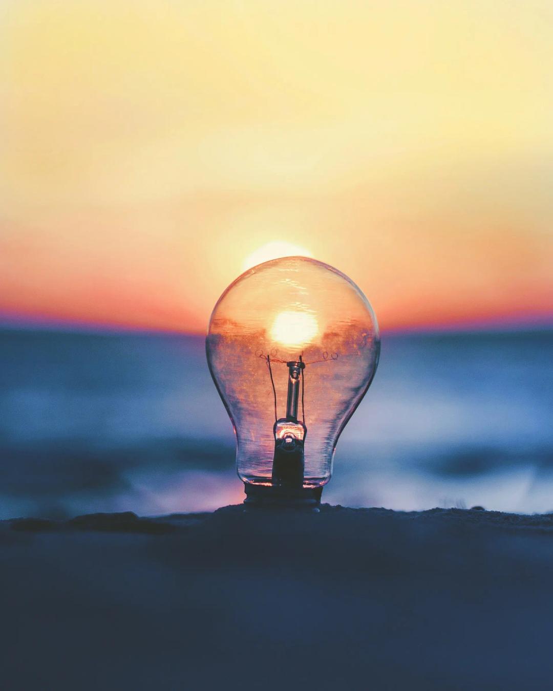 A light bulb in the sand, visualizing innovation